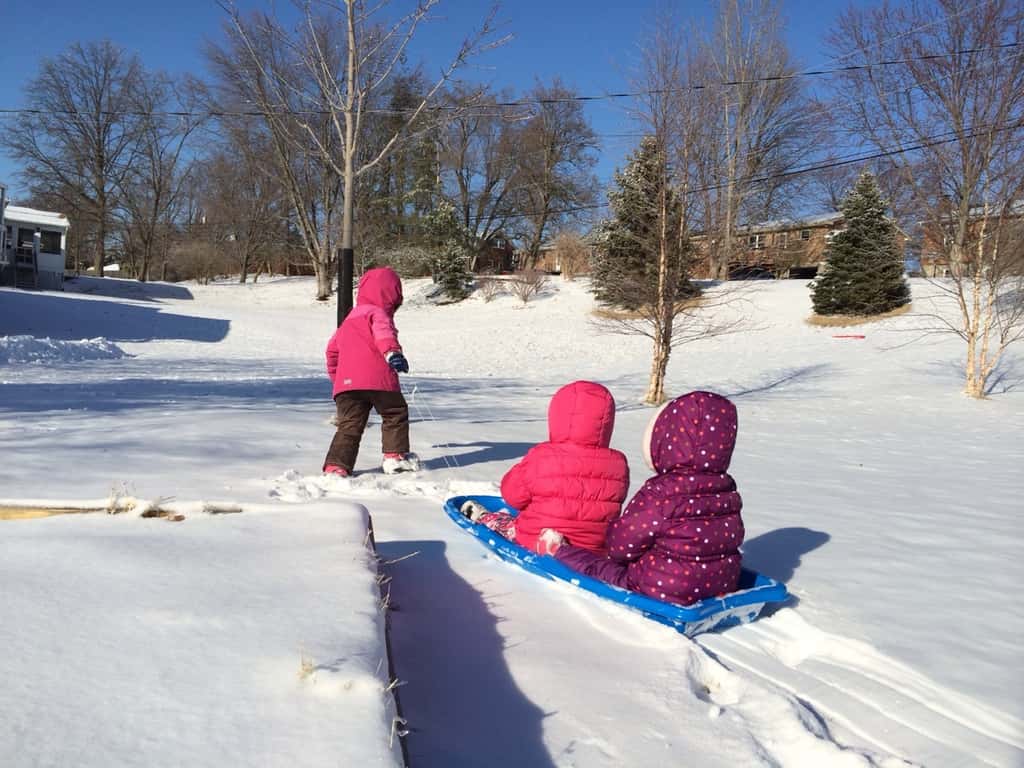 The girls and I played outside in the snow this afternoon. I’m not sure what Gwen and Josie really thought about it. They never fussed, but they didn’t smile much either. They seemed to like eating snowballs and being pulled around in the sled. Abby liked playing chauffeur. I think we all enjoyed the sunshine. It was especially exquisite reflected through the ice on the trees.