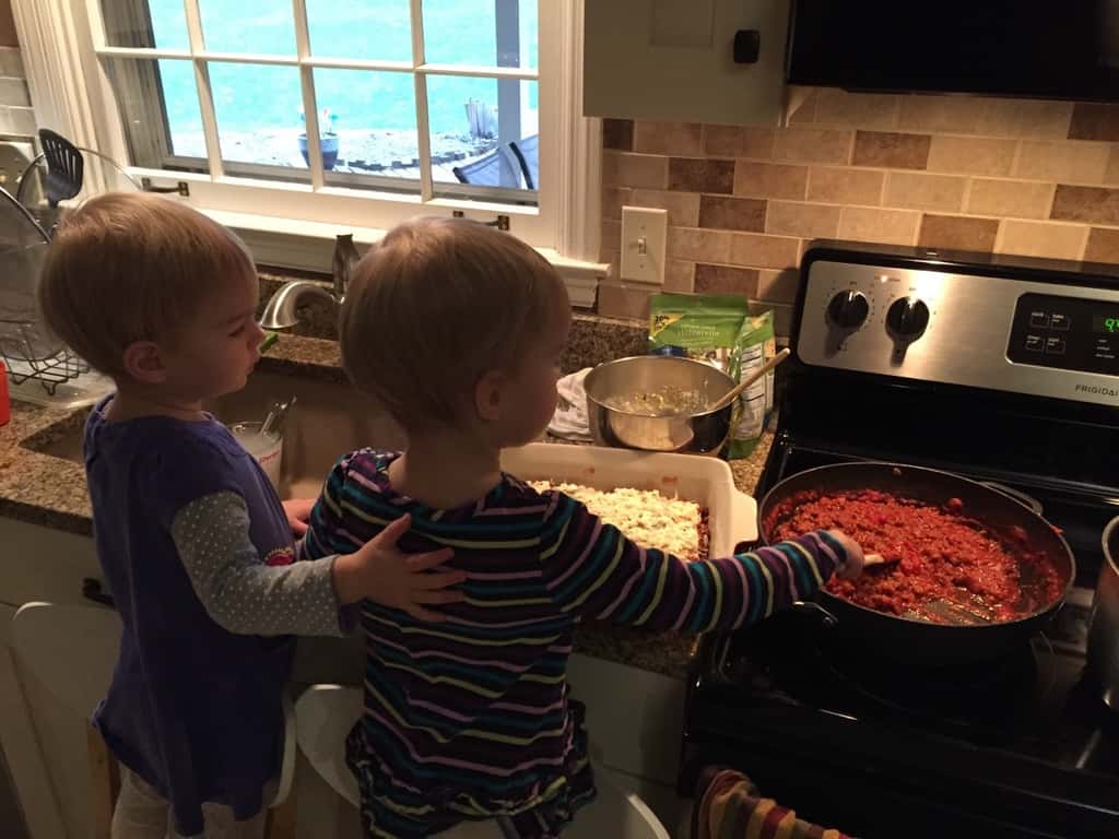 A couple of pals helping Papa make lasagna.
