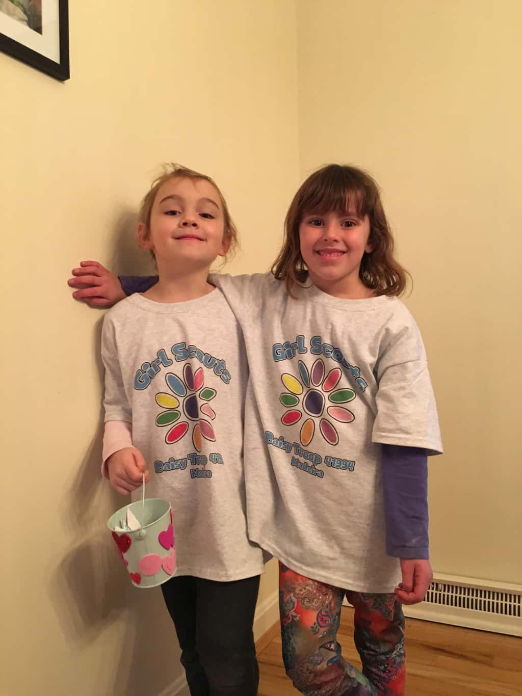 We had our third Daisy Girl Scouts meeting today. I forgot to take a picture of everyone at the meeting, but Nora and Abby were willing to pose for me later so they could show off our craft and our custom t-shirts. The girls earned the “considerate and caring” petal of the Daisy flower. I read them the book “Have You Filled a Bucket Today,” they decorated their own buckets, made caring droplets, played a bucket-filler game, had a snack, and got psyched about cookie season. All in all, it was a good meeting!