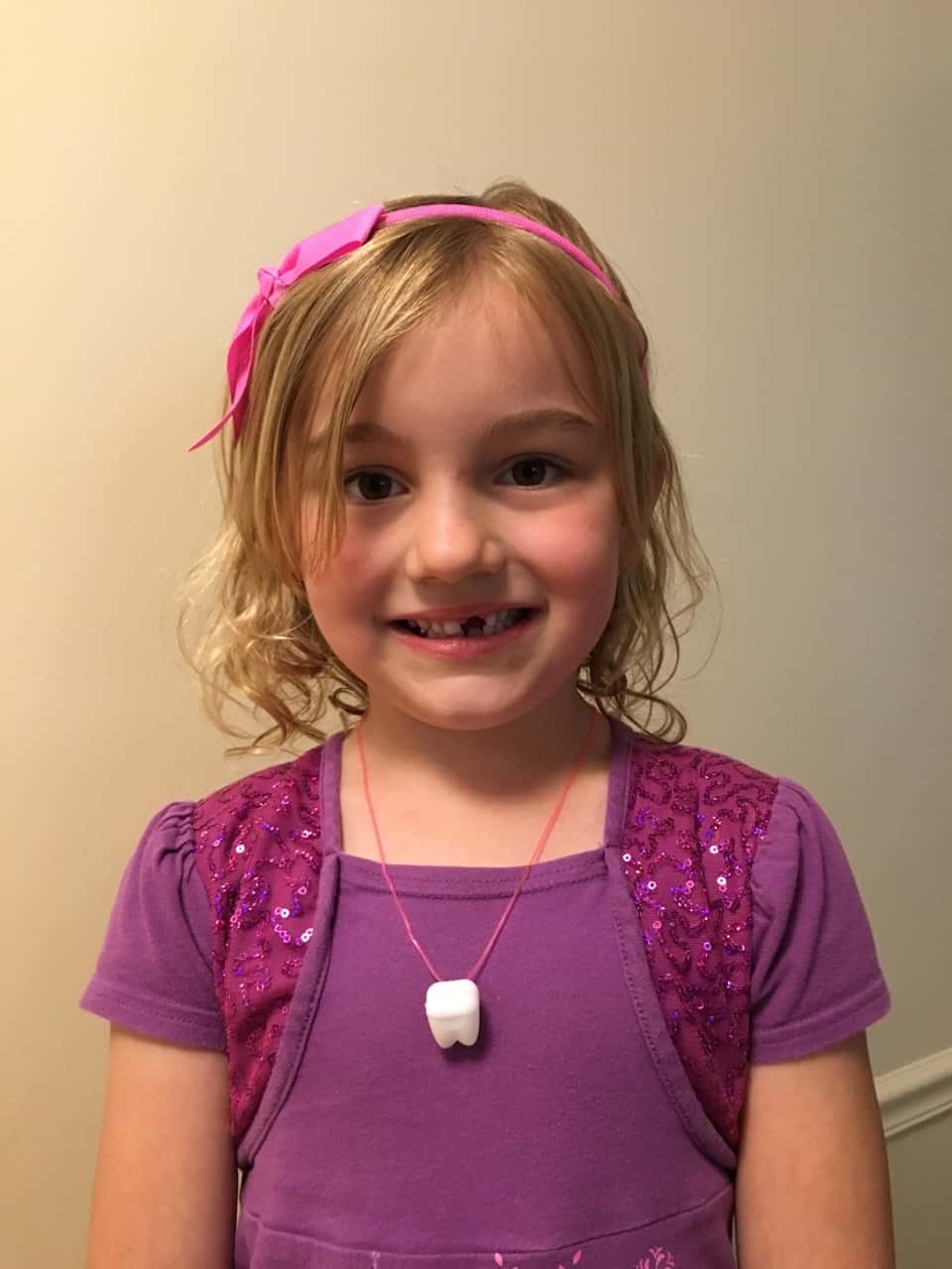 This silly girl took Nora’s advice and “punched out” her loose tooth on the morning school bus.