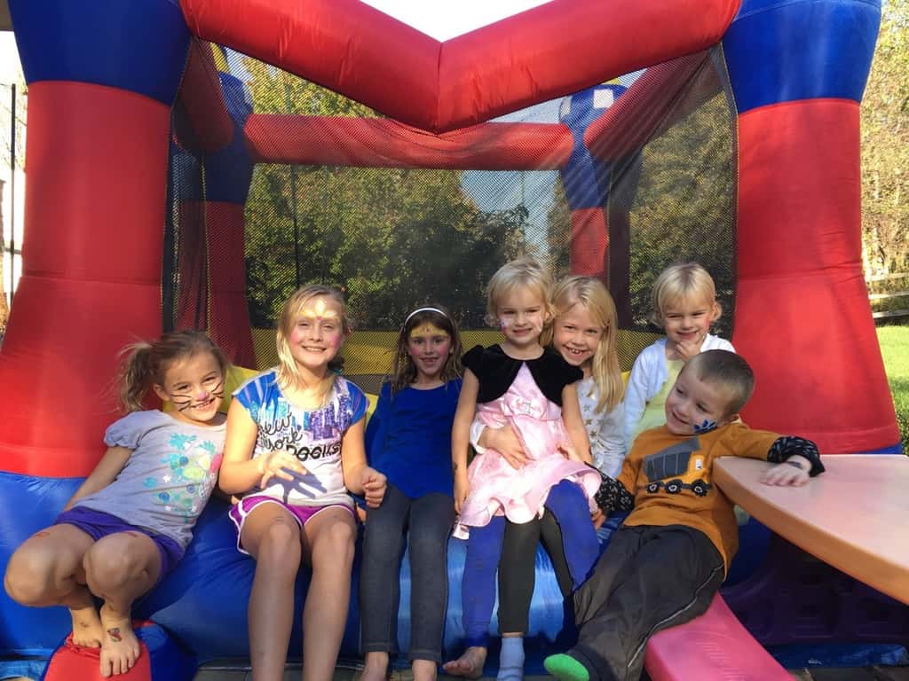 Take lots of bouncing friends, brush on some face paint, press on some tattoos, mix in a craft, eat lots of cupcakes and ice cream, and you end up with two very happy birthday girls!