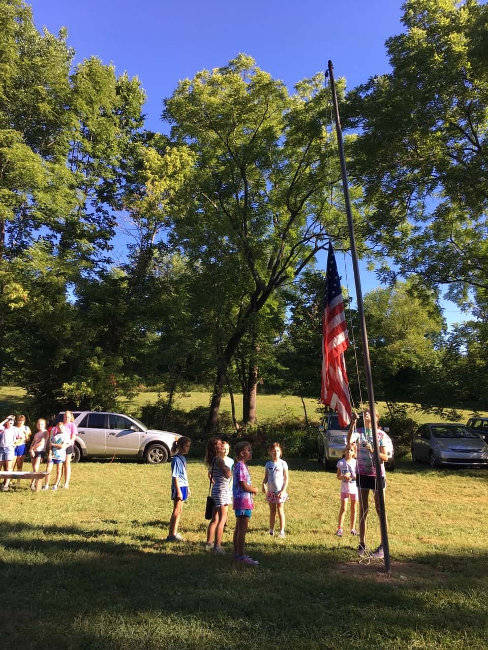 Girl Scout camp day 3 started off with our girls leading the rest of camp in the opening flag ceremony. After that, the day flew by with a talk about graphic design, cards for a service project, a nature scavenger hunt, sun s'mores, a group skit, a spider web craft, singing, creek time, hiking, and more!