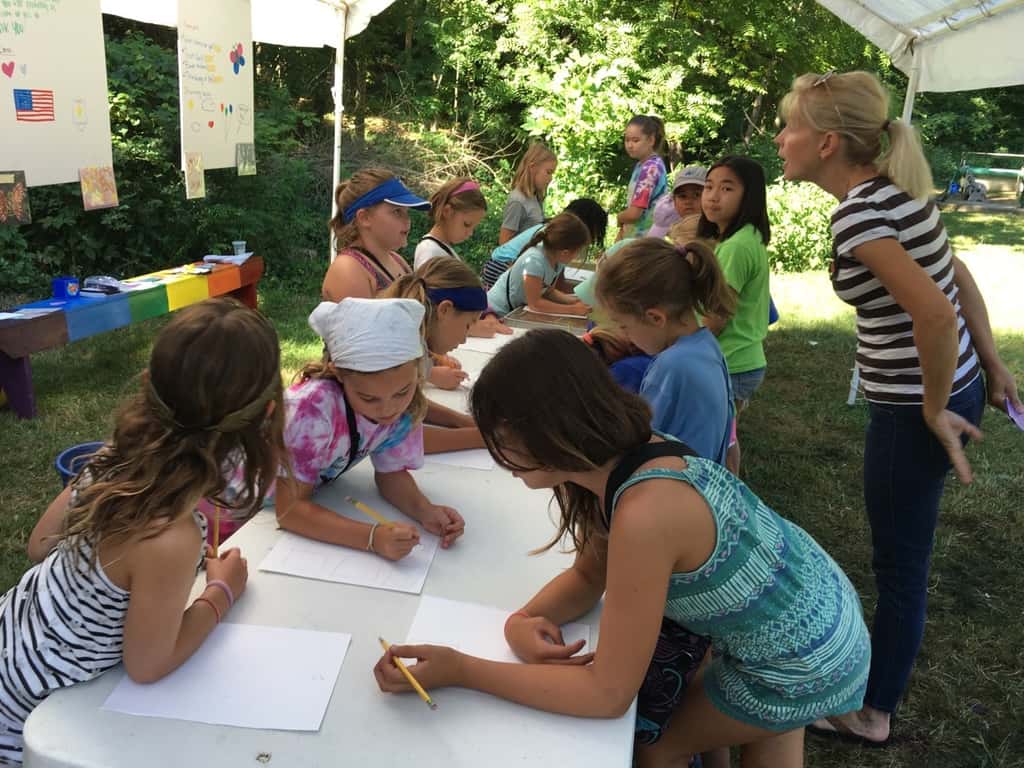 Girl Scout camp day 3 started off with our girls leading the rest of camp in the opening flag ceremony. After that, the day flew by with a talk about graphic design, cards for a service project, a nature scavenger hunt, sun s'mores, a group skit, a spider web craft, singing, creek time, hiking, and more!